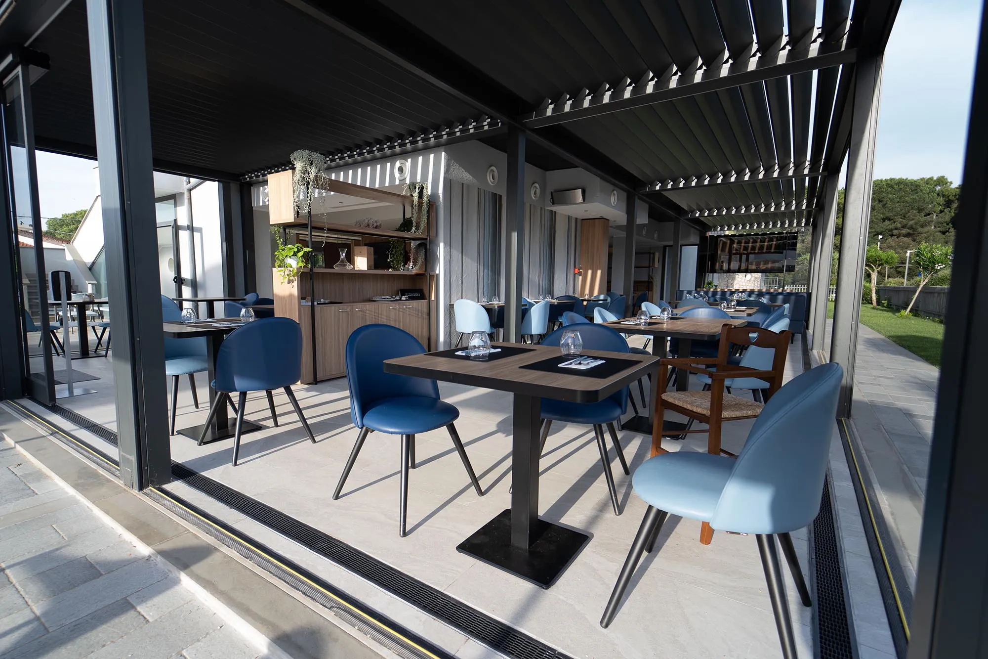 Pictured is a part of the restaurant set up with tables and chairs and laid out for guests.